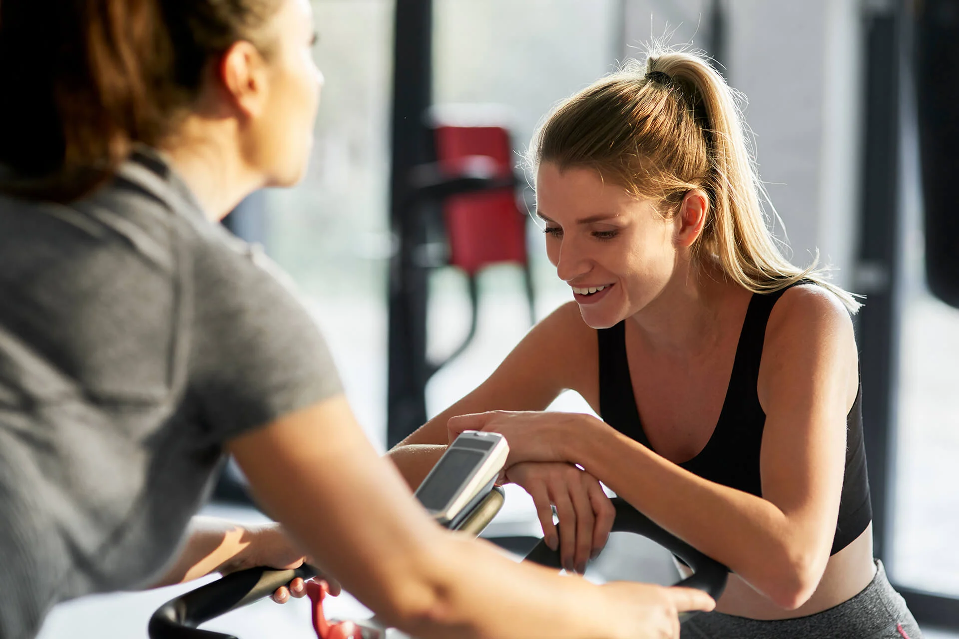 personal-trainer-with-woman-in-fitness-center